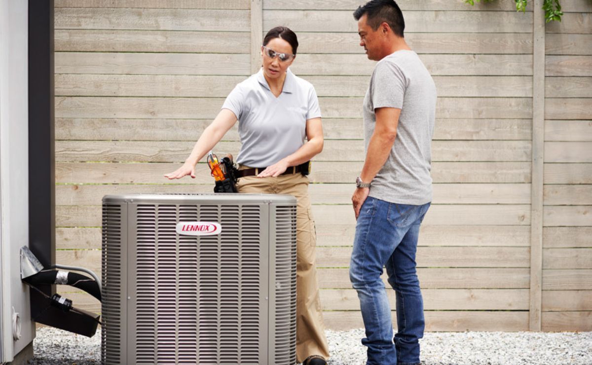 a trained hvac specialist for the brand lennox is helping a customer with their hvac system